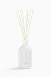 Diffuseur Antica Farmacista avec palmes balayées par le vent pour une ambiance naturelle.