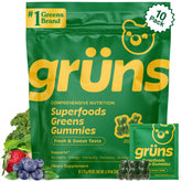 Gommes Grüns Super Greens pour adultes près d'une bouteille, soutien digestif potentiel.