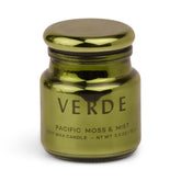 Bougie Paddywax Chroma en verre metallique avec couvercle, ambiance lumineuse et décor élégant.