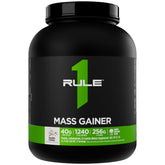 Rule1 Mass Gainer: verre shaker avec poudre pour énergie rapide pendant l'entraînement.