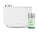 Aera diffuseur intelligent affichant White Tea pour une ambiance apaisante dans le salon.