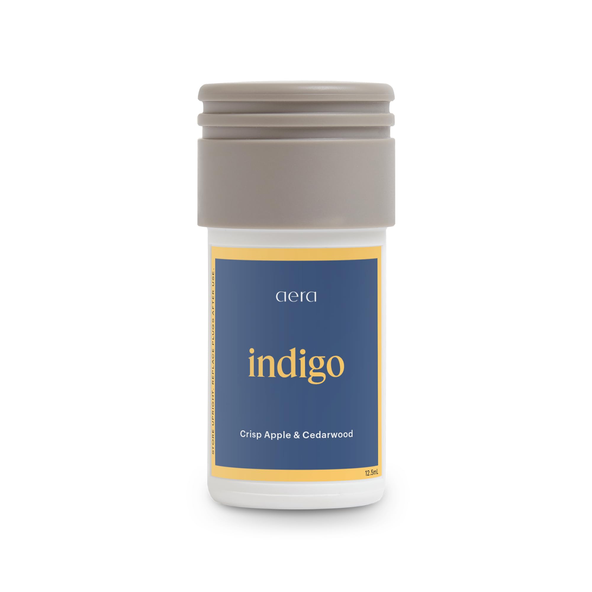 Parfum Aera Mini Indigo: bouteille pomme et cèdre, ambiance fraîche et naturelle.