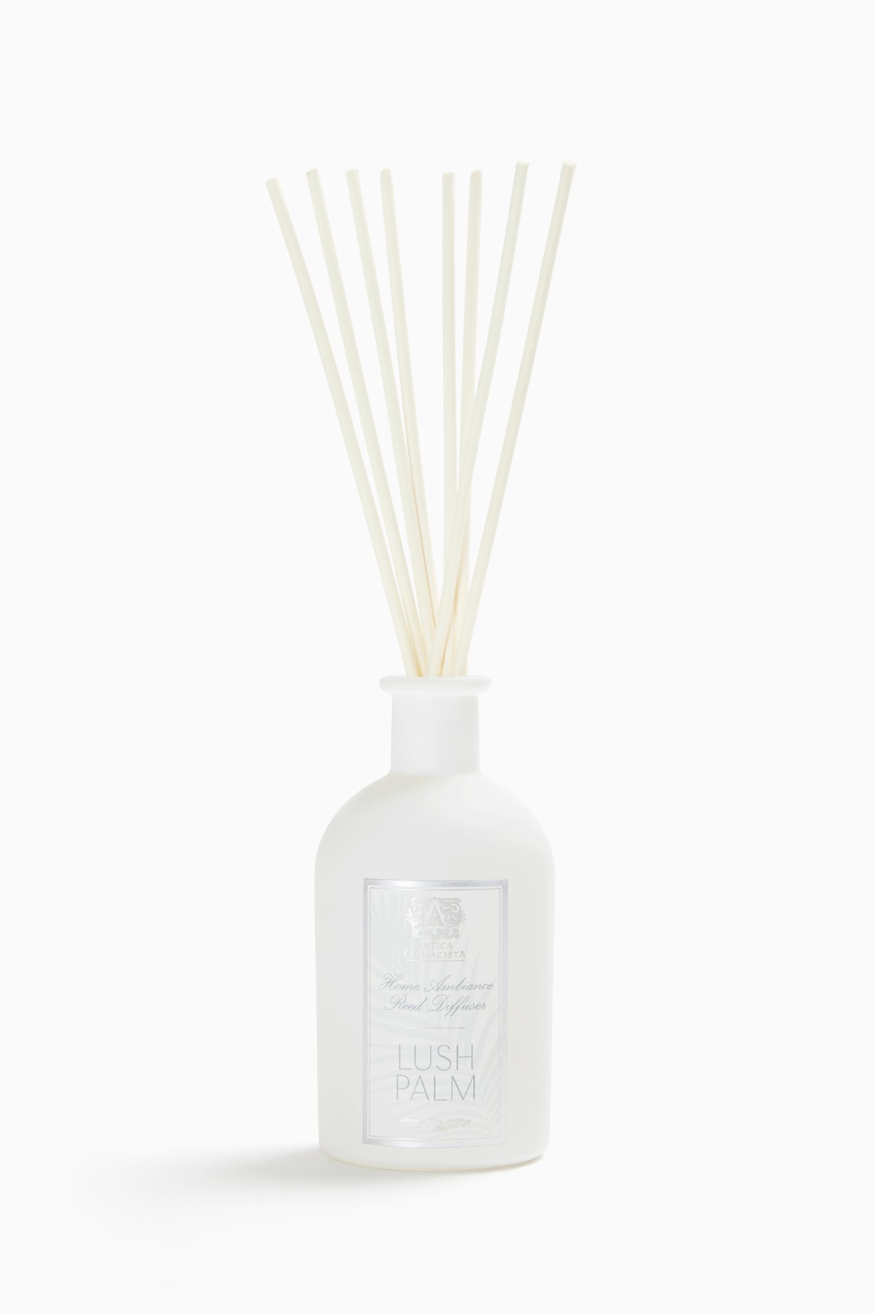 Diffuseur Antica Farmacista avec palmes balayées par le vent pour une ambiance naturelle.