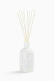 Diffuseur Antica Farmacista avec palmes balayées par le vent pour une ambiance naturelle.