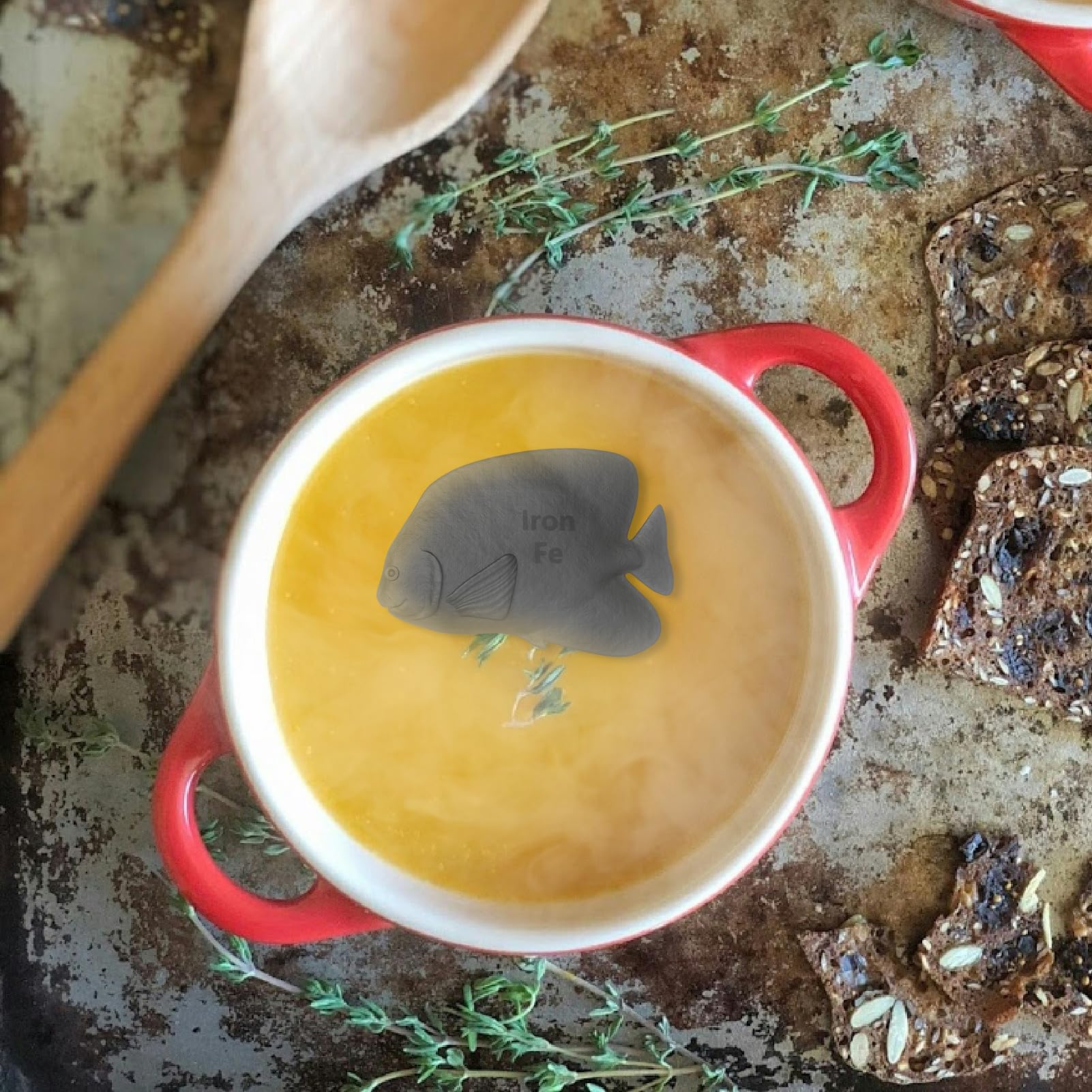 Aurionix Iron Fish près d'un bol de légumes, peut enrichir les plats en fer biodisponible