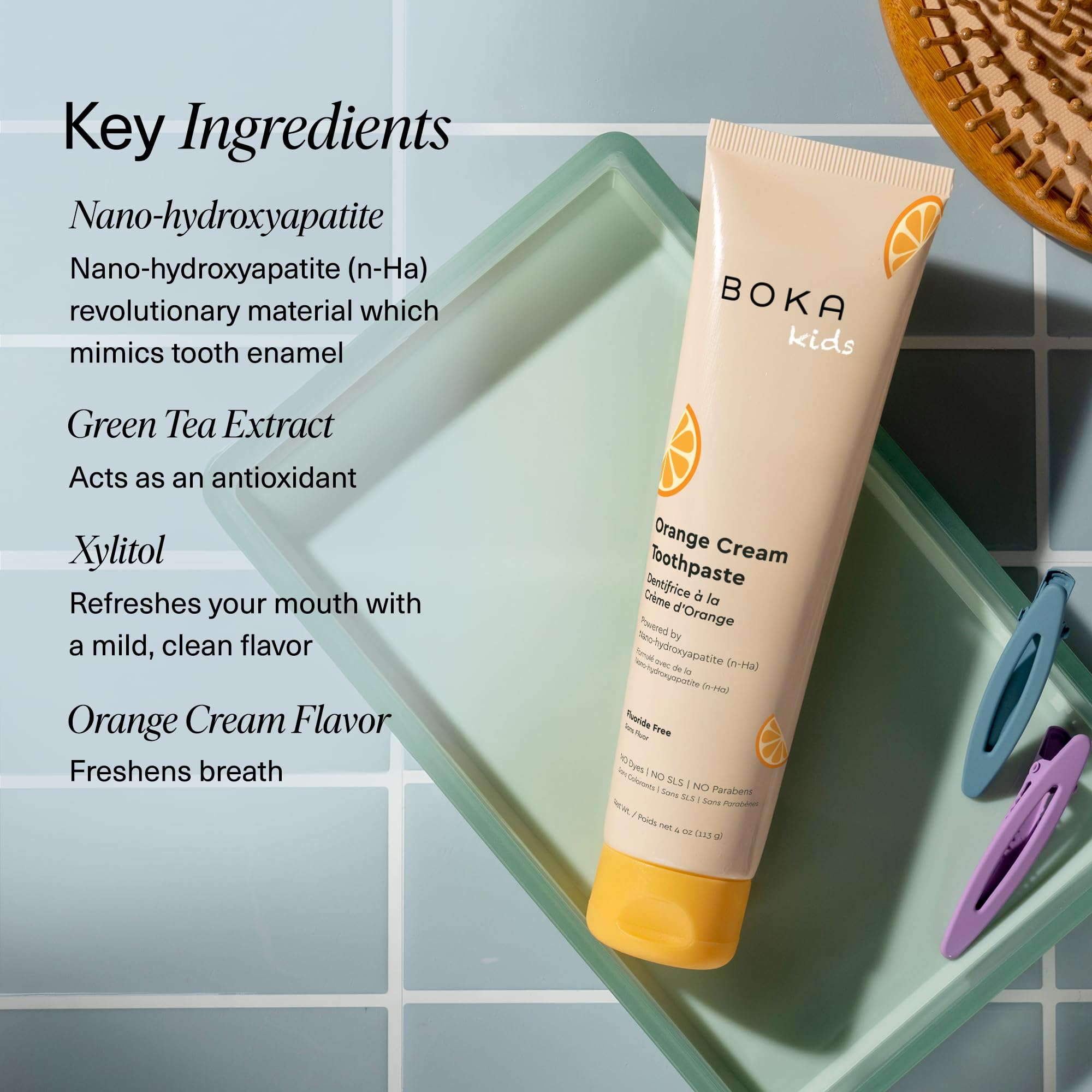 Enfant utilisant le dentifrice Boka orange crème