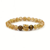 Bracelet Dare to Mystic perles 8 mm quartz rutile doré, énergie et concentration.
