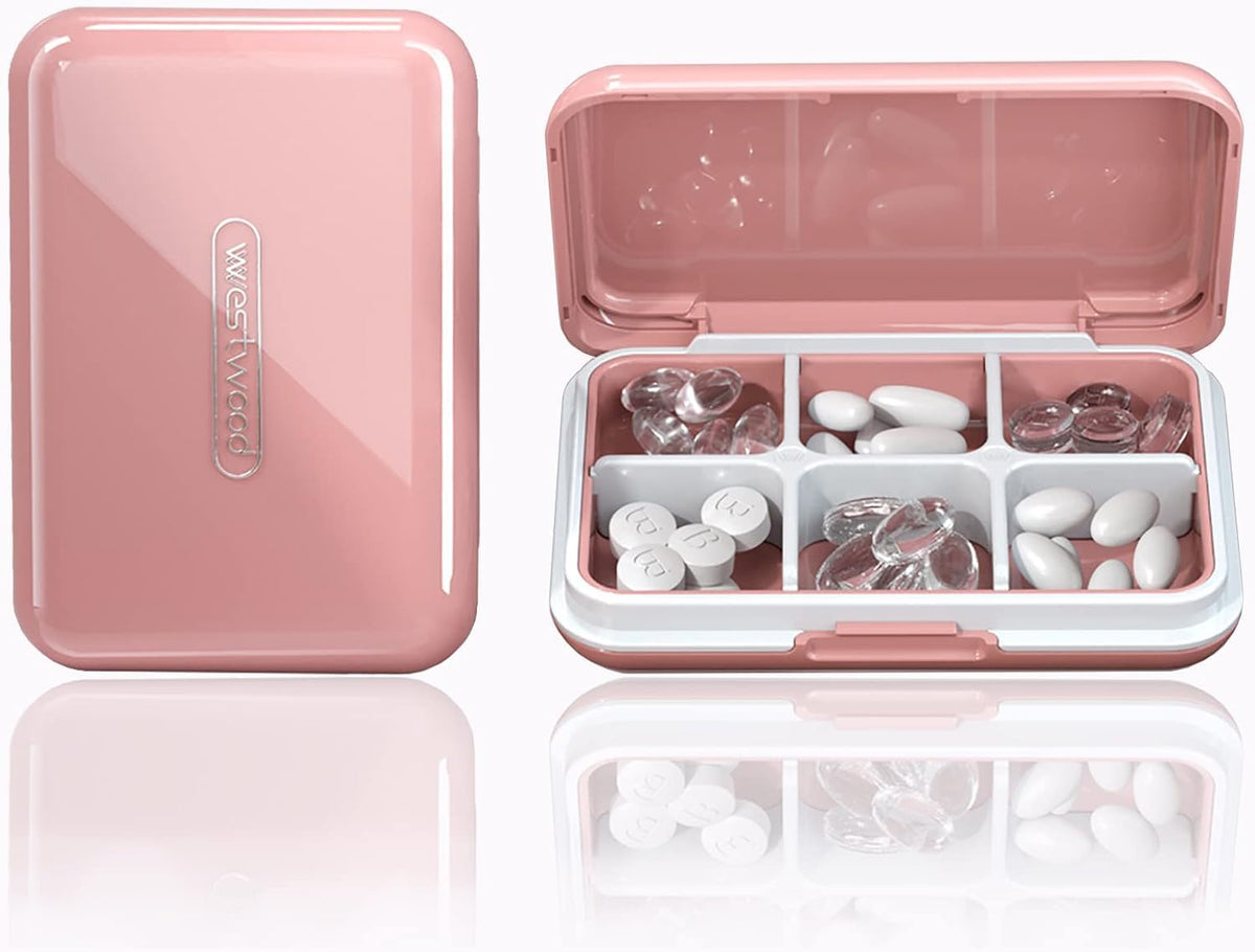 Boîte à pilules de voyage DUBSTAR rose, pratique pour médicaments et vitamines en déplacement.