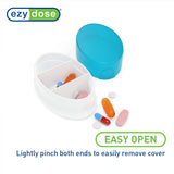 EZY DOSE: boite pilules ovale rose, accès pratique pour votre routine matinale.