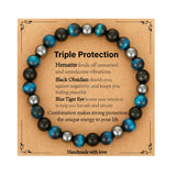 Bracelet Gnamy triple protection avec œil de tigre, énergie stabilisante possible.