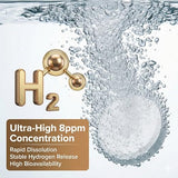 Verre avec tablettes HerbX en dissolution, eau légèrement hydrogénée prête à boire.