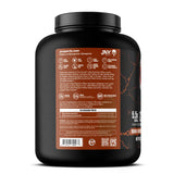 JNX SPORTS The Curse Whey Double Chocolat cuillere-doseuse pres du pot preparation rapide
