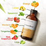 Majestic Pure Citrus Oil Blend près des zestes de pamplemousse et citron pour une expérience aromatique.