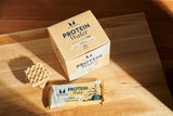 Barres protéine whey isolée Myprotein vanille intérieur, mélange lait et protéines de qualité.