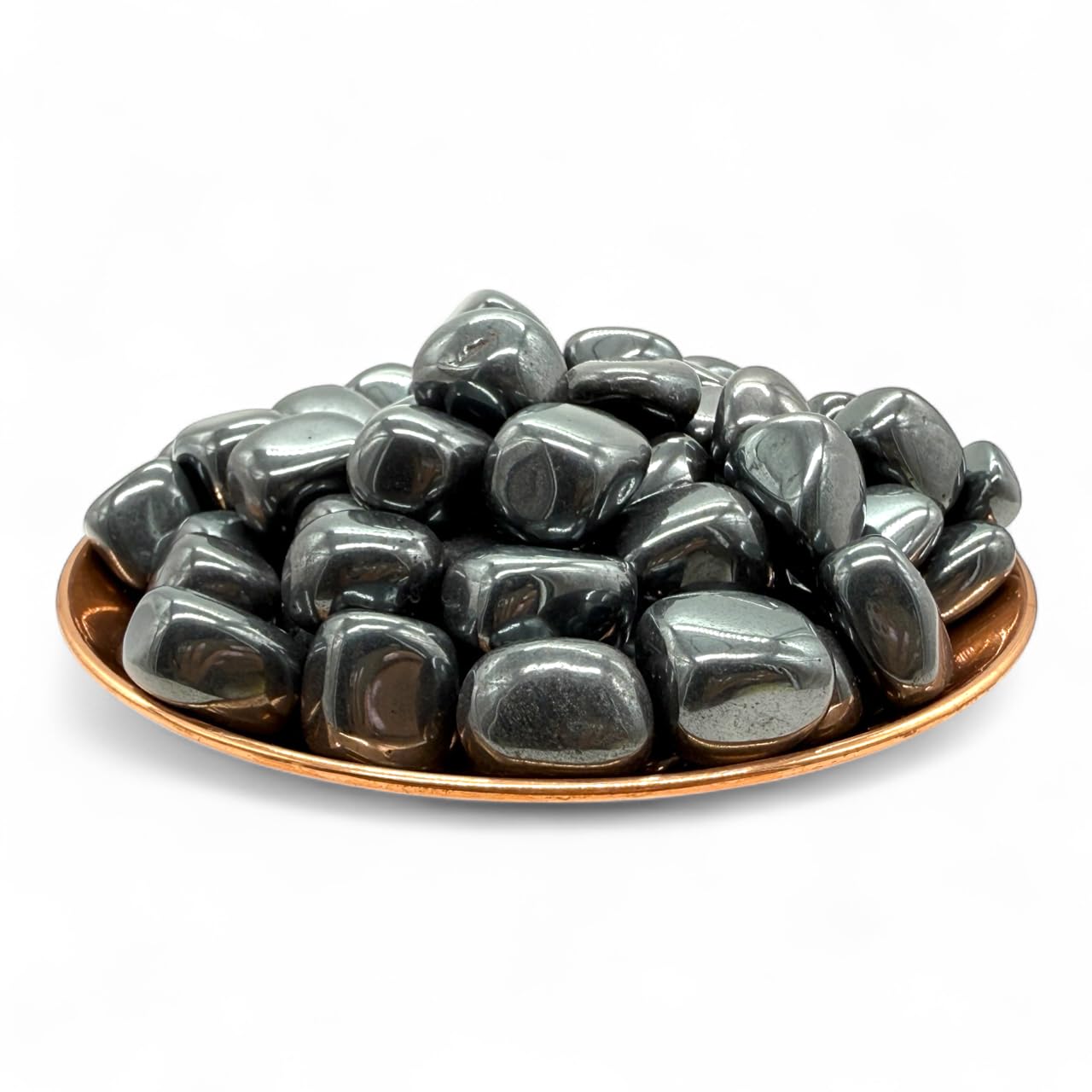 Pachamama Essentials Hématite, pierre roulée sur table, évoque stabilité et énergie vitale.