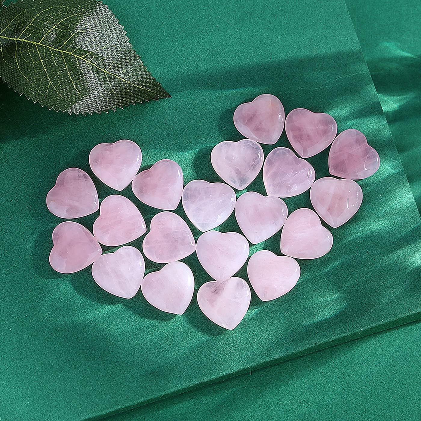 Gros plan sur un cœur rose quartz QINJIEJIE en main, parfait pour la détente et les rituels.
