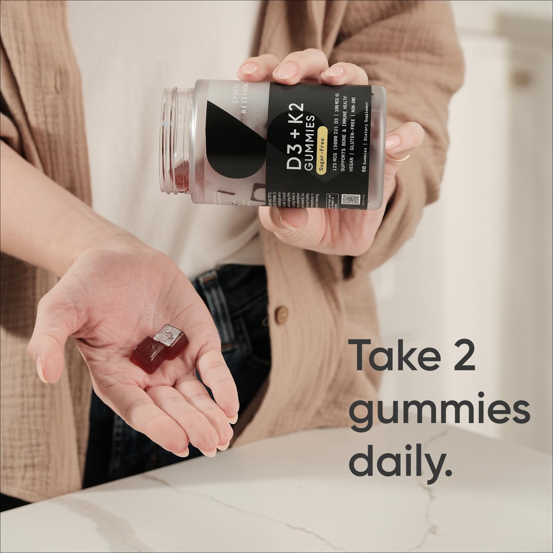 Pouring Sports Research vegan D3 + K2 gummies for easy daily intake.