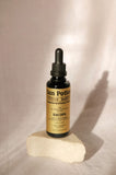 Sun Potion Bacopa Transcendent Elixir, verre sur le bureau évoquant une pratique de bien-être
