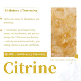 SUNYIK géode citrine frontale brillante, éclairage doré chaleureux.